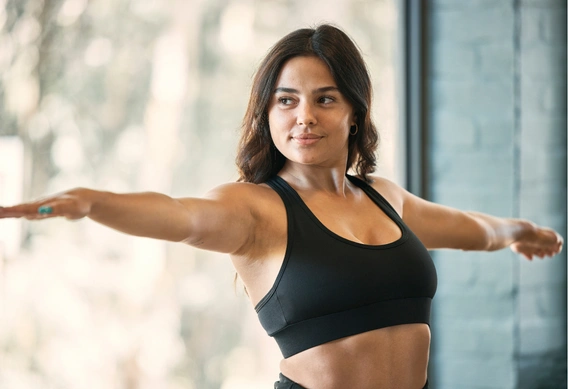 Woman who takes GLP-1 medication doing strengthening yoga exercise